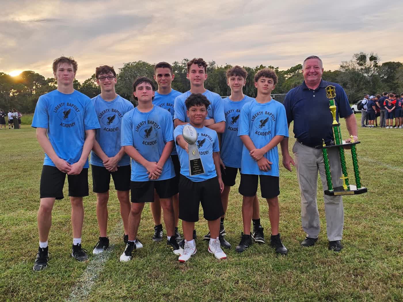 Liberty Baptist Academy Hawks athletes with trophies
